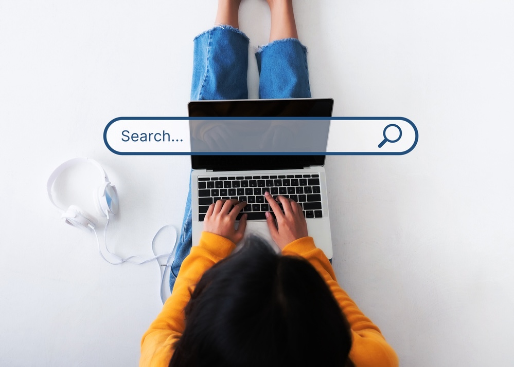 Top view of woman searching on her laptop, search engine optimization