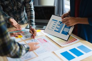 Custom website planning session showing designers reviewing wireframes and layouts for a Nashville business