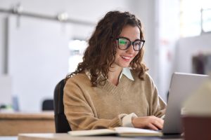 Team member managing website content on laptop using an easy to manage website system